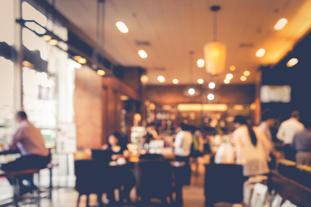Blurry coffee shop interior with people.