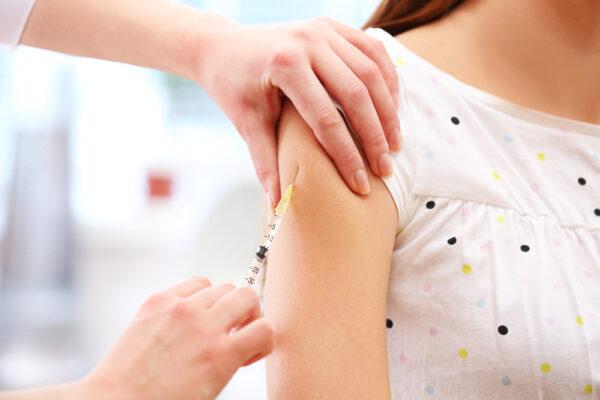 Person receiving a vaccine in the arm.
